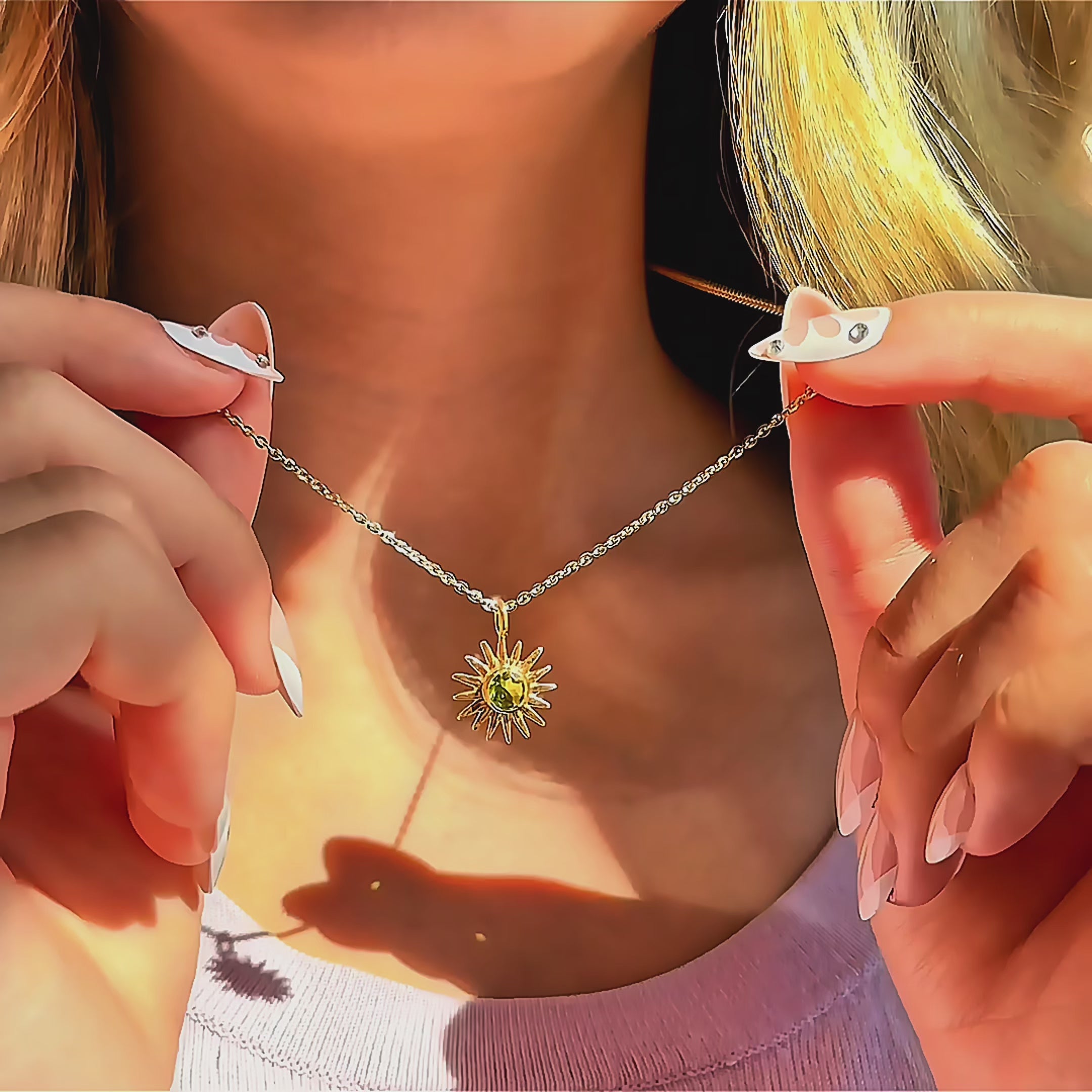 Close-up of a custom birthstone sun pendant necklace held on a delicate gold chain, featuring a radiant sunburst charm with a personalized gemstone center, minimalist celestial birthstone jewelry for women, meaningful gift for mom, daughter, or girlfriend, perfect for Valentine’s Day, birthday, or everyday layering necklace