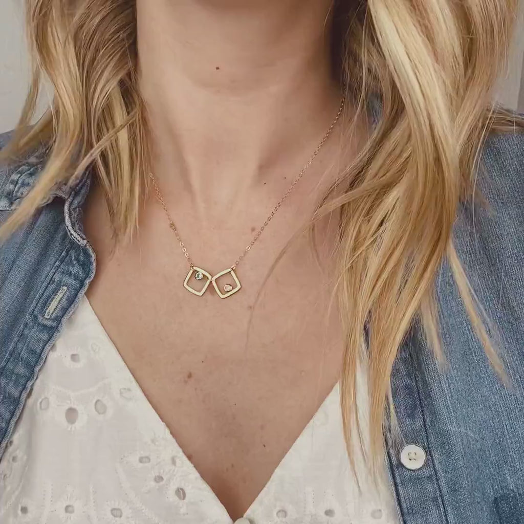 Video of model in white top wearing the gold filled square geometric necklace with kyanite and moonstone birthstones. 