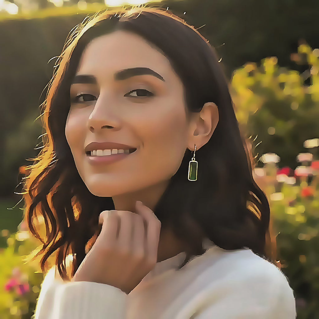 video showcasing delicate baguette cut birthstone earrings in gold vermeil, featuring an elongated rectangular gemstone that catches the light beautifully, shown worn for scale and movement; available in all birthstones for personalized gifting, including January garnet, February amethyst, March aquamarine, May emerald, July ruby, September sapphire, November citrine, and more; elegant minimalist design perfect for everyday wear, birthdays, anniversaries, and holiday gifts