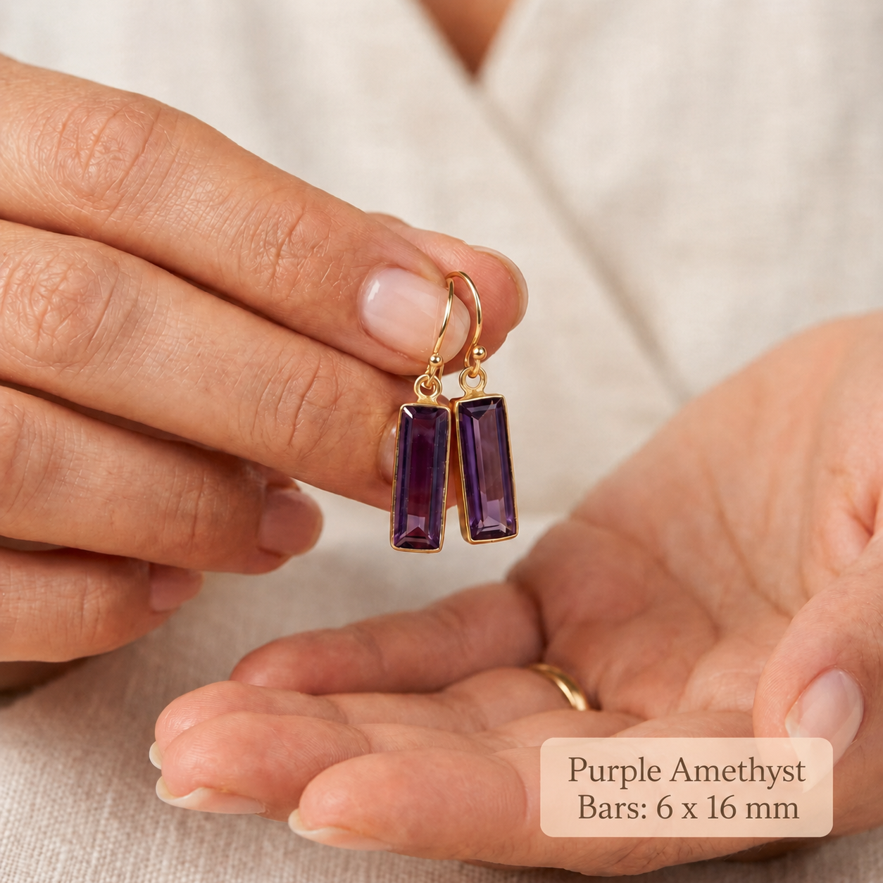 Hand holding purple amethyst bar earrings showing 6 x 16 mm stone size