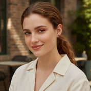 Model wearing tiny baguette gemstone stud earrings