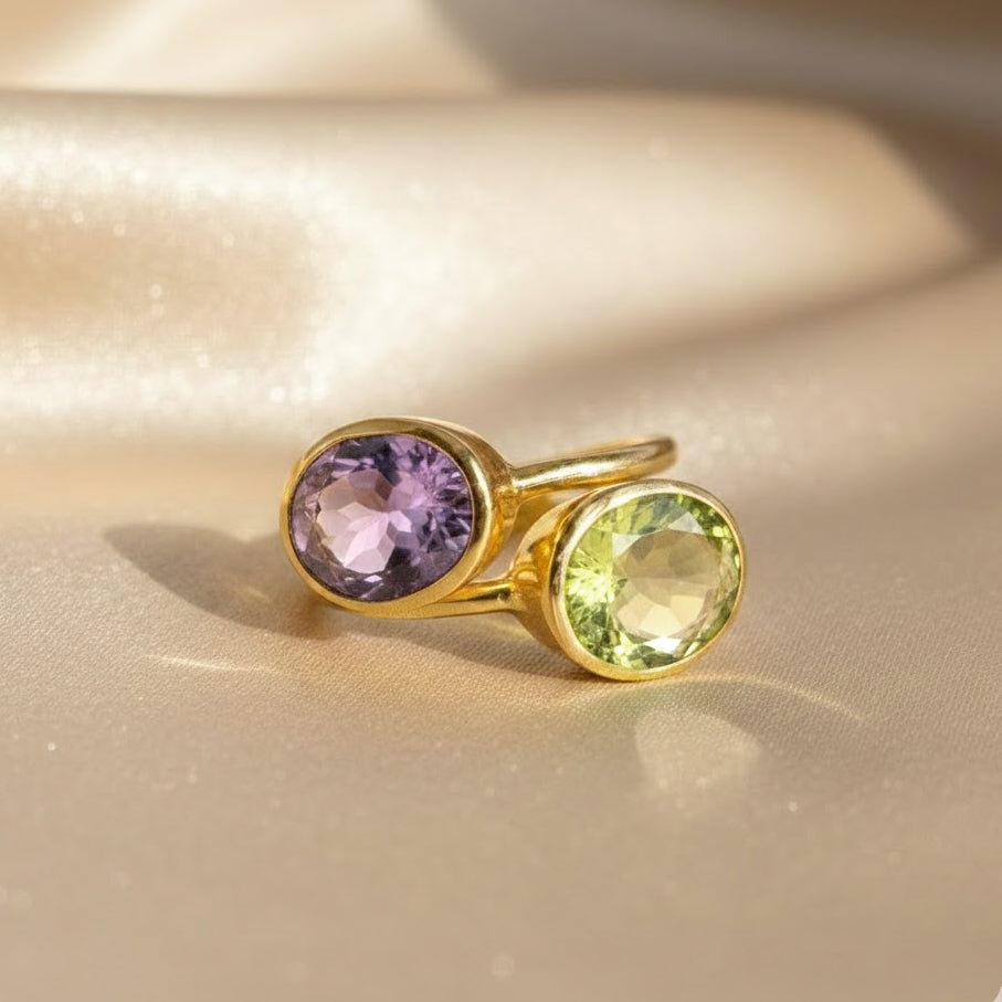 Green amethyst and purple amethyst oval bezel set rings shown together, February birthstone gemstone ring styling, minimalist stackable gold rings for color mixing