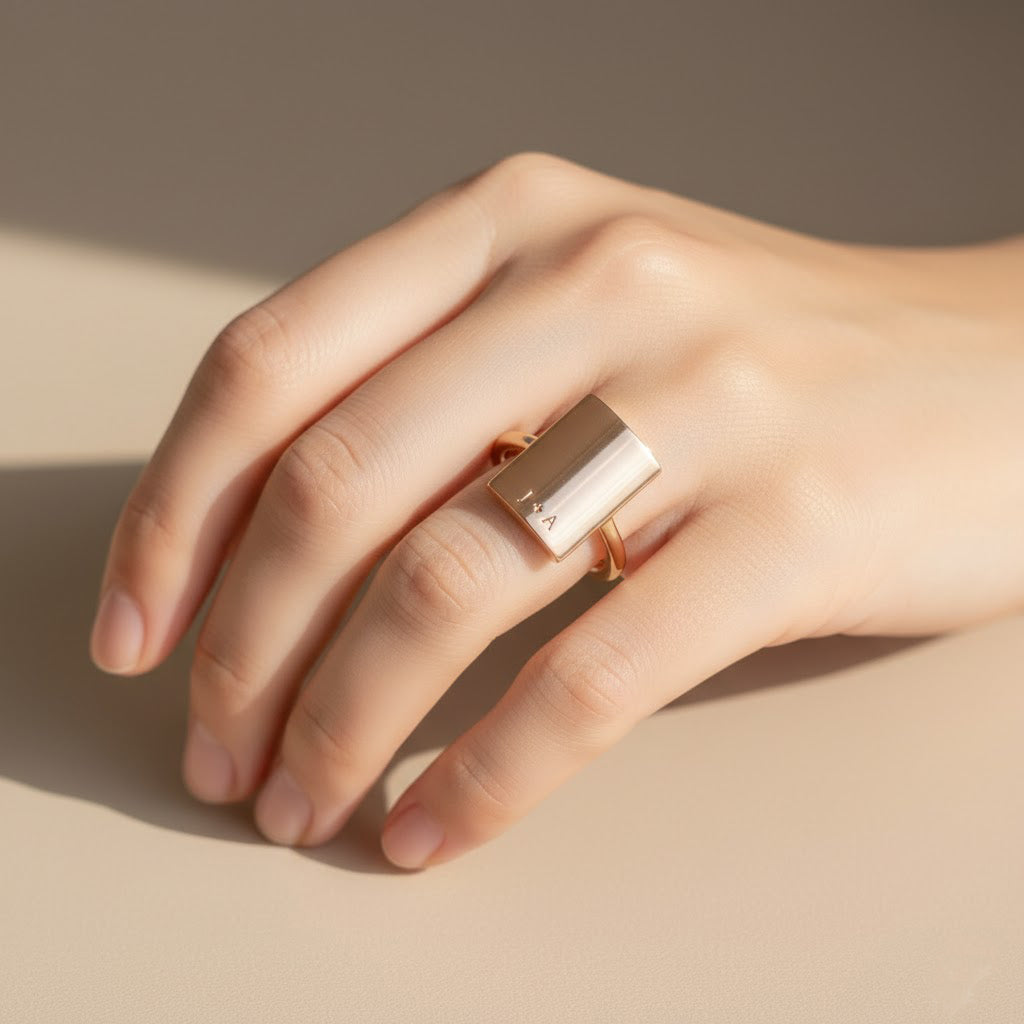 Model is wearing a sterling silver rectangular name plate ring with the phrase you are loved engraved. 