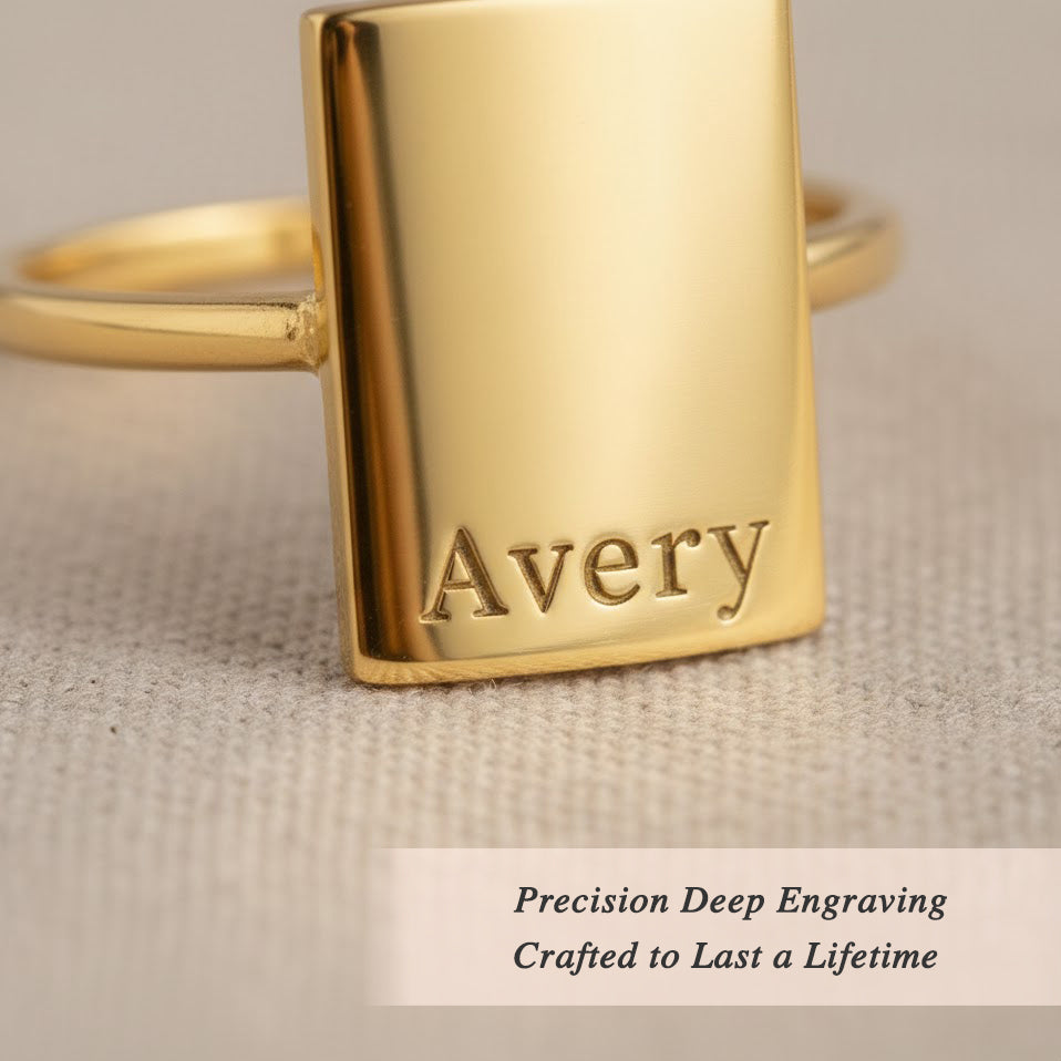 Deep custom engraved rectangular gold ring with name Avery, precision engraving detail on modern minimalist signet ring for women