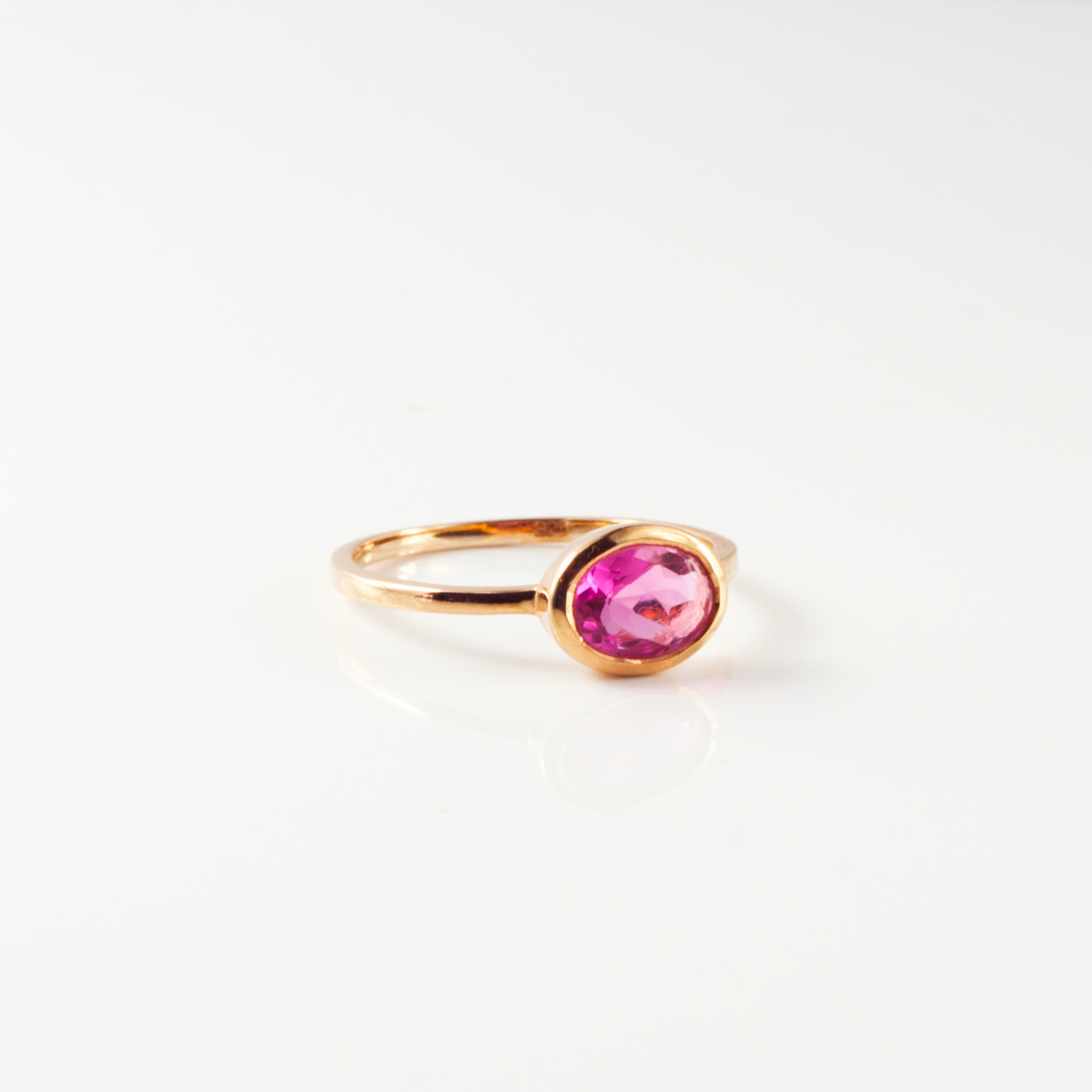 a rose gold ruby quartz ring shown on white background. stackable! Stacking rings, bezel set, small oval, tiny oval, dainty oval, birthstone rings, birthstone ring, birthstone jewelry, red gemstone, red birthstone, july birthstone, july gemstone, stack set, stacking rings, gemstone ring, birthstone ring, mother's day gift for her, gift for mom, gift for fiance, gift for girlfriend, wedding jewelry, bridesmaid jewelry, anniversary jewelry, birthday gift, christmas gift, valentine's day gift