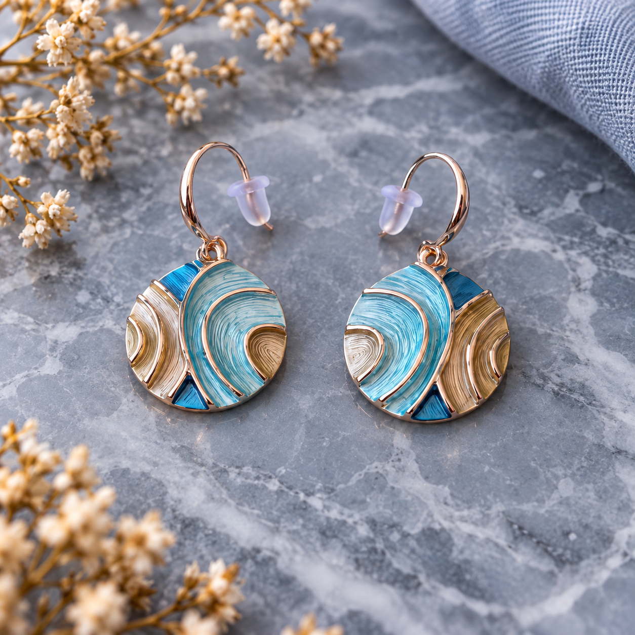 Tidal Orbit turquoise abstract circle earrings with layered ripple design displayed on gray stone

