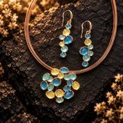 Boho bubble cluster necklace and matching drop earrings in Sea Glass Glow colors on dark stone

