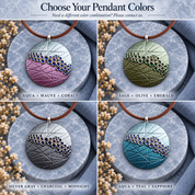 
Purple teal and silver round mosaic pendant necklace displayed on gray stone


