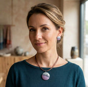 Woman wearing purple teal boho bubble mosaic pendant necklace with abstract round design

