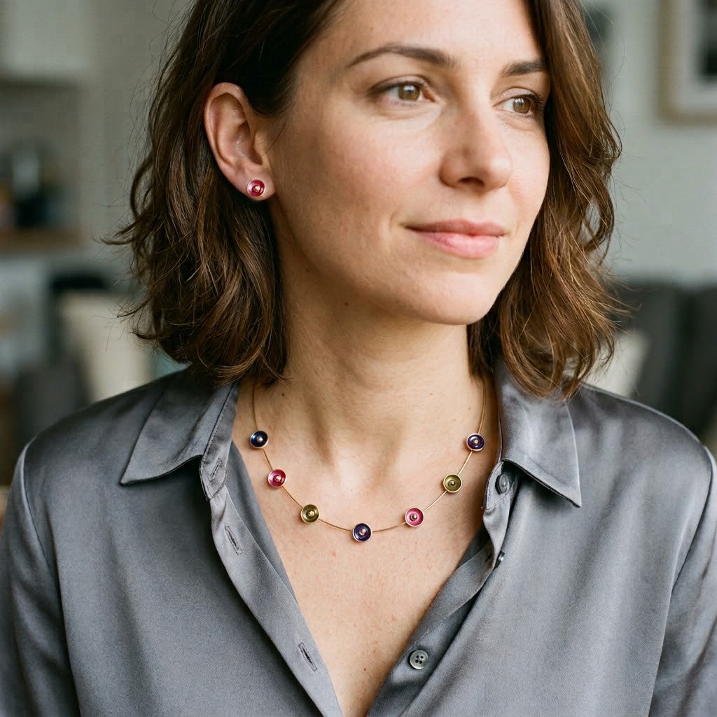 Woman wearing colorful Color Bloom station necklace with plum top outdoors