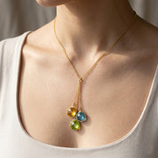 Woman wearing birthstone lariat necklace, dainty gold Y necklace with colorful gemstones
