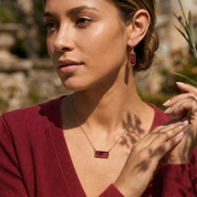 Model wearing Adira Ruby Quartz drop earrings outdoors in natural light