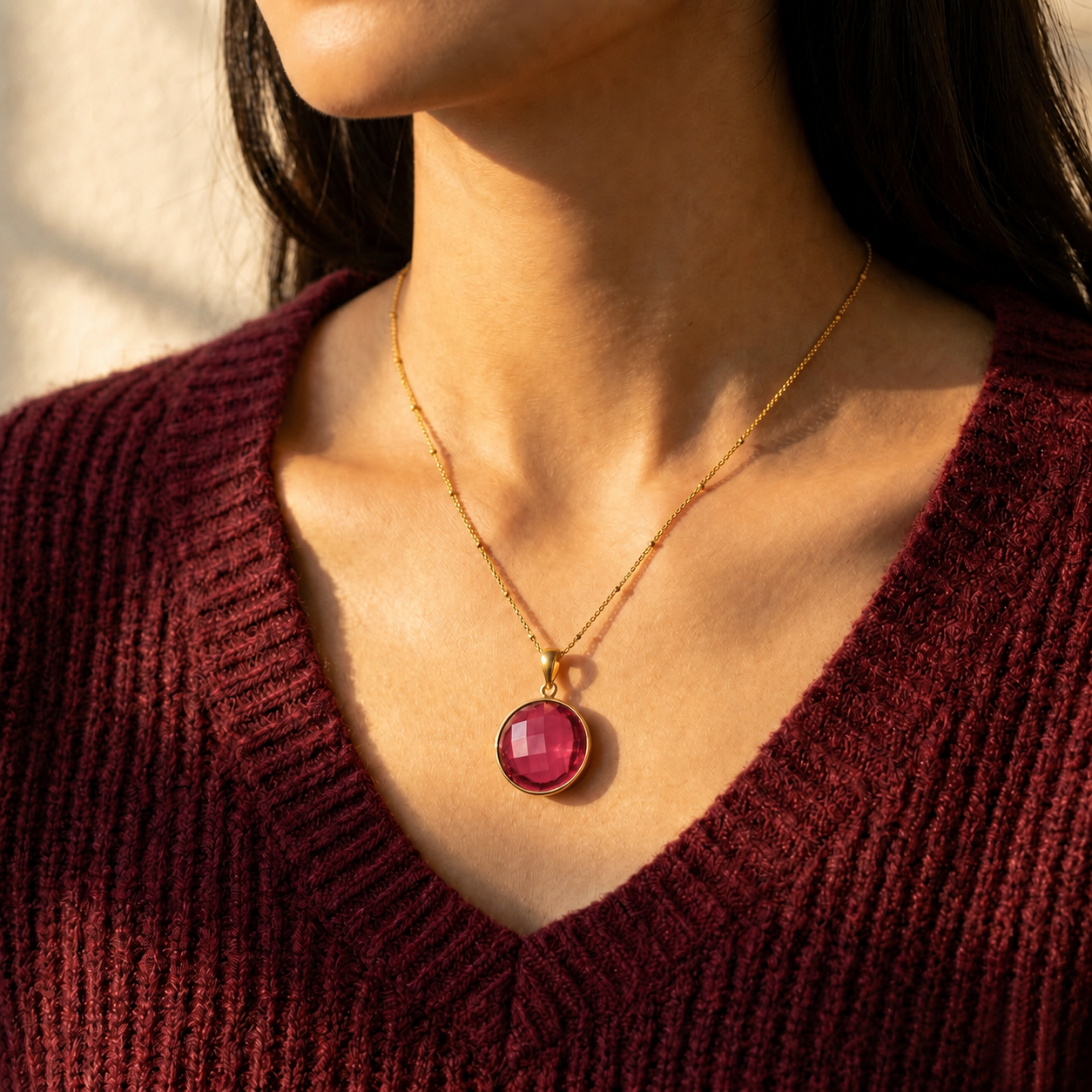 Ruby quartz teardrop necklace in gold finish with deep red gemstone sparkle.
