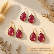 Ruby quartz teardrop earrings shown in sterling silver and gold with warm sunlight and dried floral accents.