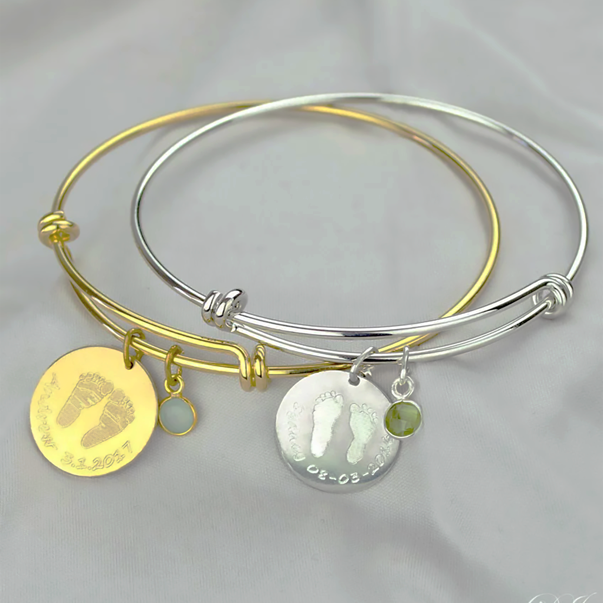 A gold and a silver footprint bangle bracelet with birthstones. Silver, gold, aqua chalcedony birthstone, peridot quartz birthstone, footprint jewelry, baby keepsake jewelry, child's heirloom, handmade gift for mom, christmas gift for mom or grandma, push present for expecting mother, baby stats, name, birthdate