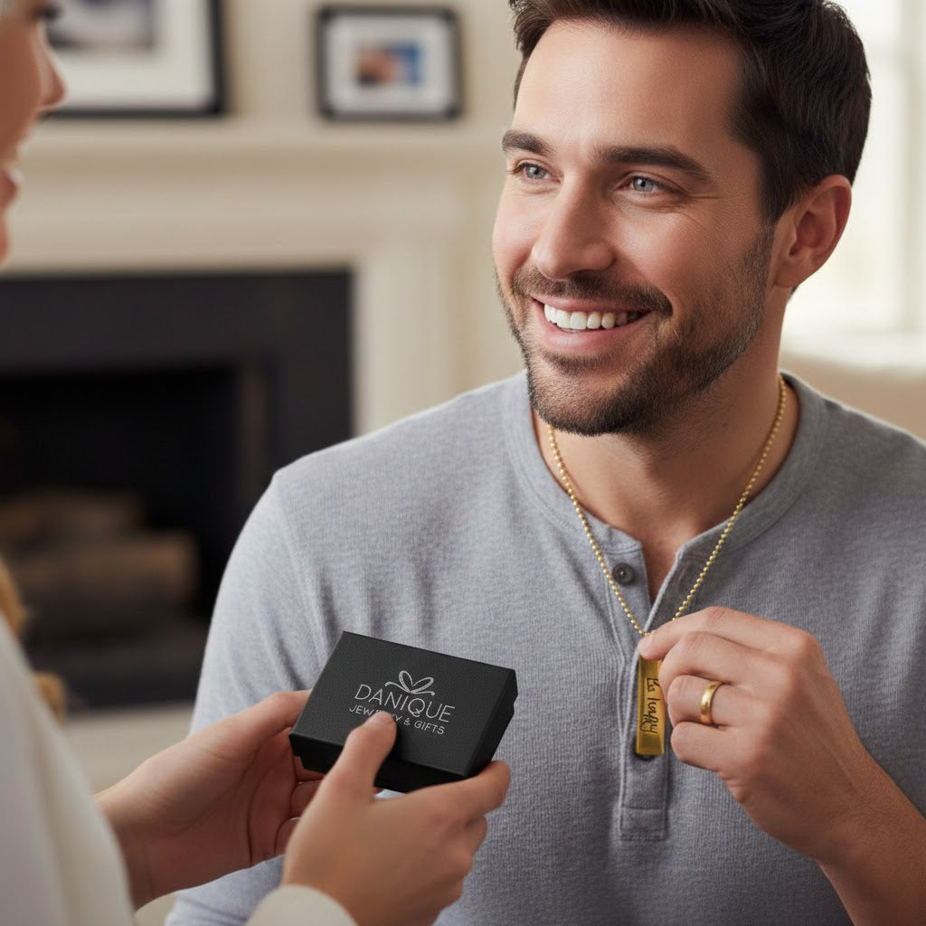 Couple exchanging a personalized engraved dog tag necklace gift box, tag visible, moment of surprise and emotion. Gift-ready custom dog tag jewelry for boyfriend, husband, dad or partner on anniversaries, birthdays or Father’s Day.