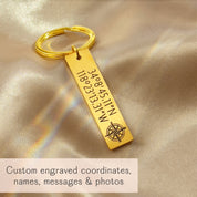 Gold stainless steel bar keychain engraved with GPS coordinates and compass icon on champagne satin, custom location keyring for anniversary or long distance relationship
