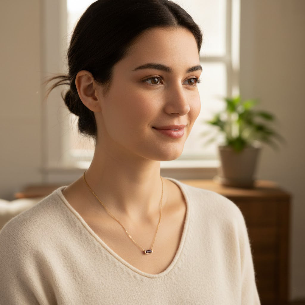 Dainty Tiny Adira birthstone bar necklace worn on a woman, showcasing the petite faceted gemstone bar in gold vermeil on a delicate chain, styled as minimalist everyday jewelry. Available in all twelve birthstones with optional personalized engraving, making it a meaningful gift for birthdays, bridesmaids, graduations, anniversaries, or anyone who loves subtle, elegant gemstone necklaces.