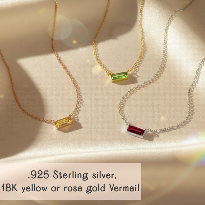 tiny adira birthstone bar necklaces displayed on soft champagne satin, featuring three horizontal gemstone bars in yellow, green and deep red set in different metal finishes, including 925 sterling silver, 18k yellow gold vermeil and 18k rose gold vermeil, each on a delicate chain, showcasing the minimalist tiny birthstone bar necklace design, customizable for any birth month and perfect as a dainty everyday piece or personalized gift for women