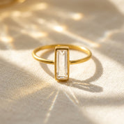 Clear quartz bar ring in gold vermeil, faceted rectangle April birthstone stacking ring