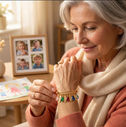 Grandmother wearing a personalized gold family birthstone bangle with multiple engraved name and gemstone charms.