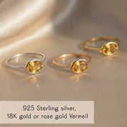 Close-up of a small oval citrine gemstone set in a minimalist birthstone ring, showcasing natural November birthstone color. Available in sterling silver, yellow or rose vermeil gold