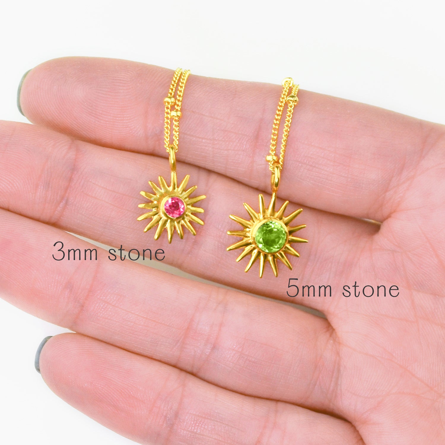 Side-by-side comparison of two sunburst birthstone necklaces with 3mm and 5mm gemstones, displayed in hand to show scale, sparkle and detailing of the radiant sun design. Personalized birthstone jewelry available in sterling silver, gold filled and rose gold filled, perfect for birthdays, Mother’s Day, Christmas, bridesmaids or best friend gifts. All birthstones offered for meaningful customization.