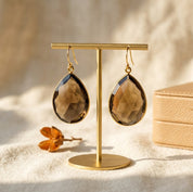 Smoky quartz earrings set in gold with teardrop shape and rich brown crystal
