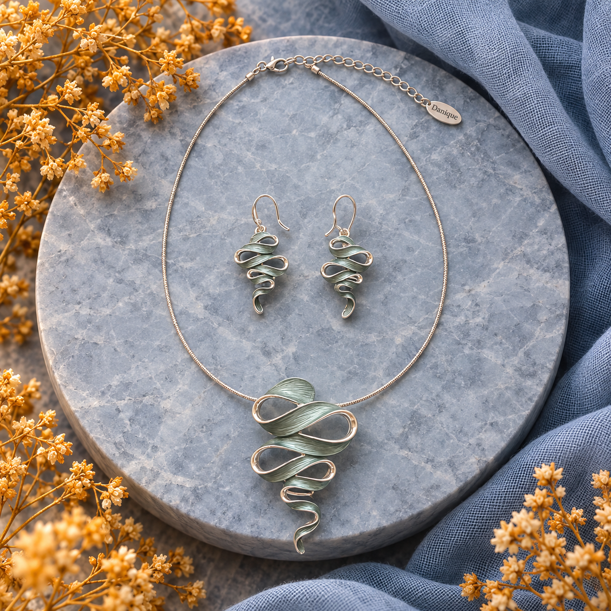 Natural Sage Ribbon Cascade necklace and matching drop earrings displayed on gray stone

