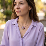 Woman wearing Lavender Burgundy Sculptural Loop pendant necklace with lavender blouse
