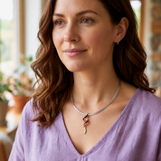 Woman wearing purple pink boho spiral pendant necklace with lavender top
