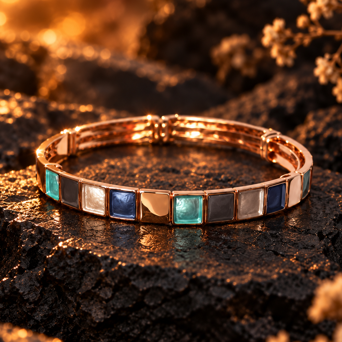 Rose gold boho Mosaic Squares bangle bracelet with teal blue gray and metallic accents on dark stone

