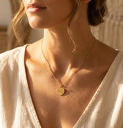 Woman wearing personalized state map disc necklace
