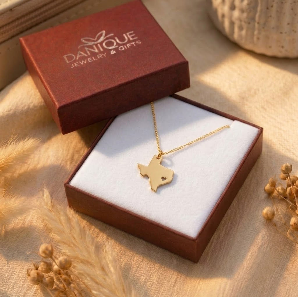 Custom gold state necklace displayed in a burgundy keepsake gift box