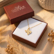Custom gold state necklace displayed in a burgundy keepsake gift box