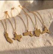 Personalized state and county map necklaces displayed on delicate gold chains