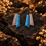 Ocean Breeze geometric Fan stud earrings with layered teal blue and rose gold panels on dark stone


