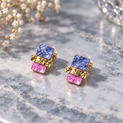 Gold stacked squares stud earrings with textured geometric design on neutral stone

