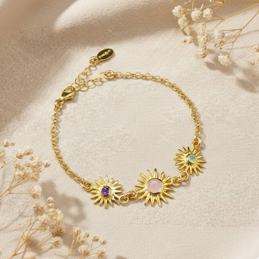 Custom sunburst birthstone bracelet for mom featuring one larger faceted gemstone for the mother and smaller birthstones for children. Personalized family bracelet crafted in sterling silver, 18k gold vermeil, or rose gold, designed as a meaningful mother’s gift.