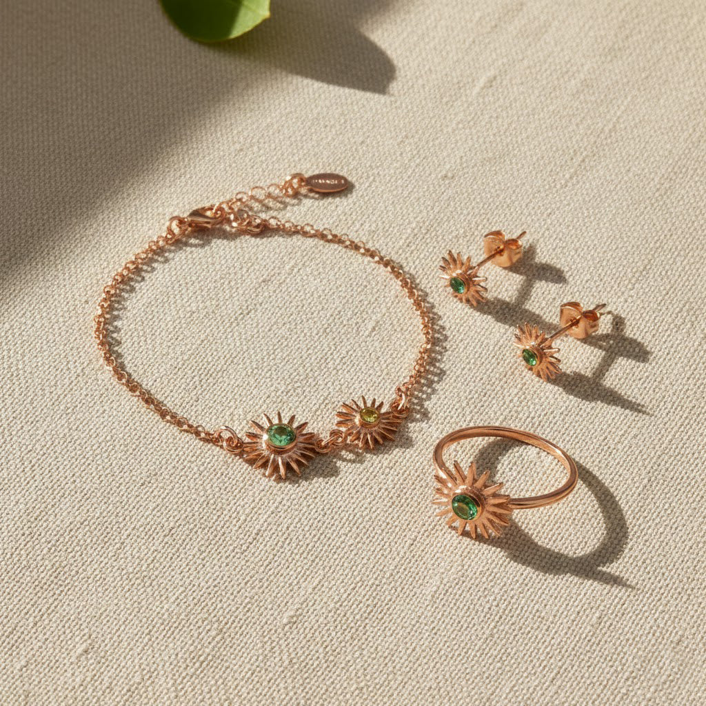 Sunburst birthstone bracelet styled with matching jewelry, featuring faceted sapphire for September and opal-inspired stone for October. Personalized mom bracelet designed as a meaningful family keepsake.