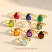 Gold teardrop stud rings available in a variety of birthstones, including natural rainbow moonstone and colorful gemstone options.