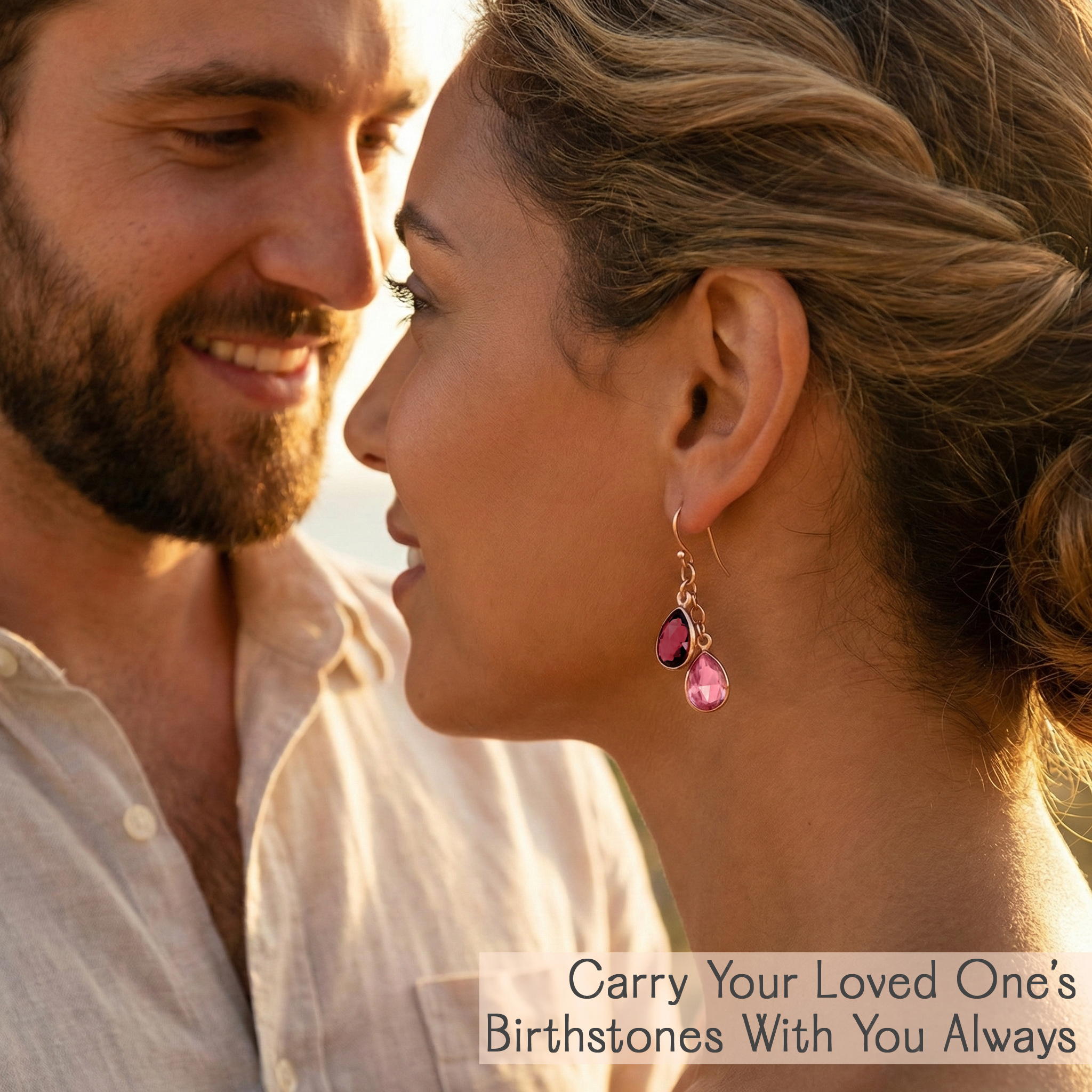 Couple smiling at each other with a focus on the woman's earrings. Handmade birthstone earrings for women featuring cascading teardrop gems in January through December options, crafted to celebrate motherhood, family bonds, and life’s treasured milestones.
