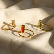 Colorful tiny baguette rings in multiple birthstones for stacking and gifting.