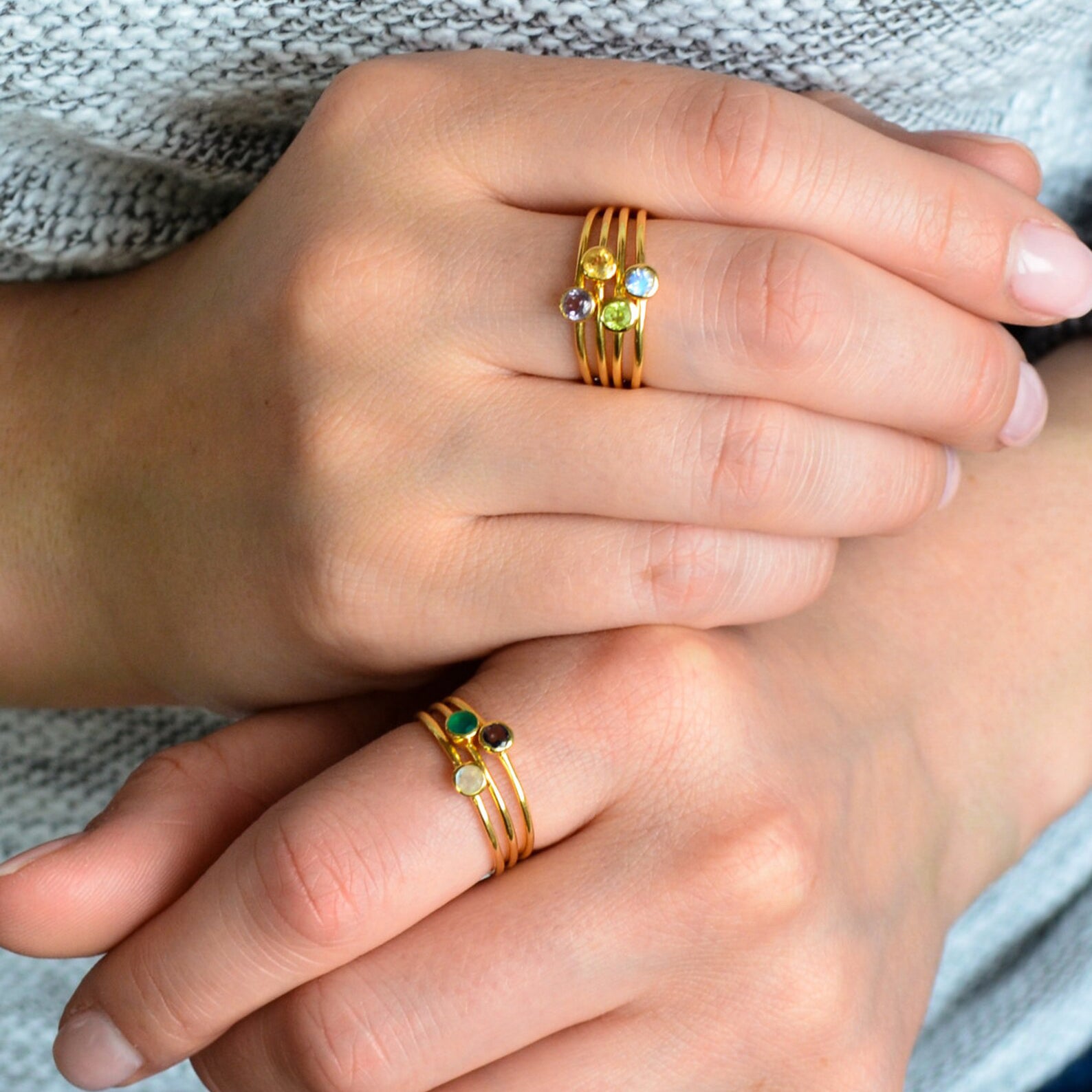 Model is stylishly stacking rings. Stackable! Ring combo with six rings stacking ring set tiny round birthstones black onyx, green onyx, peridot, blue topaz, peridot, citrine and purple amethyst. Single gold plated dainty 3mm citrine gemstone ring. November birthstone. 