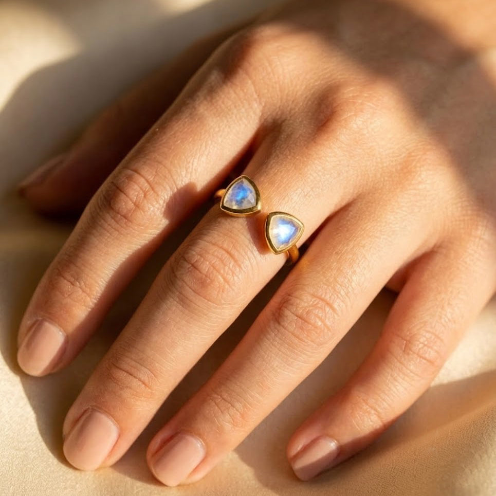 Moonstone triangle adjustable ring worn on hand, showing the open band and dainty gemstone size.