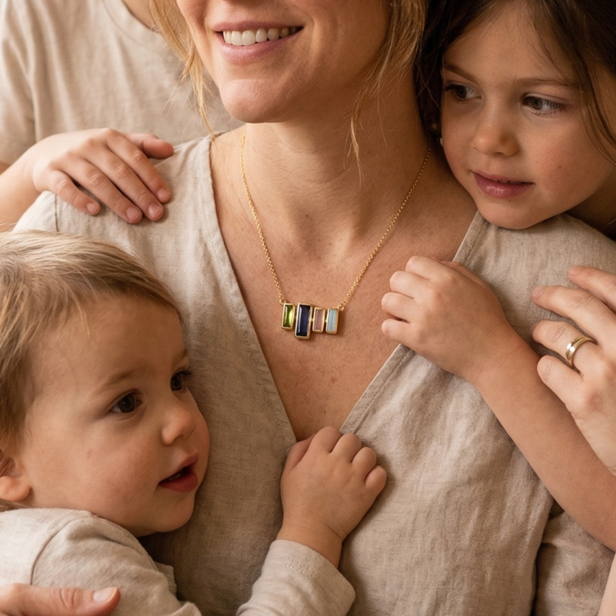 Woman holding three children in a cozy living room
