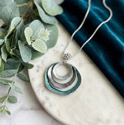 Silver and teal layered circle statement pendant necklace
