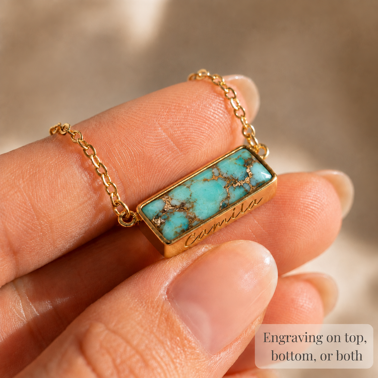 Close-up of personalized turquoise bar necklace with natural copper turquoise gemstone and custom engraving.


