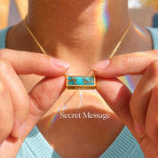 Woman holding a personalized turquoise bar necklace with hidden engraved name message on a natural copper turquoise pendant.