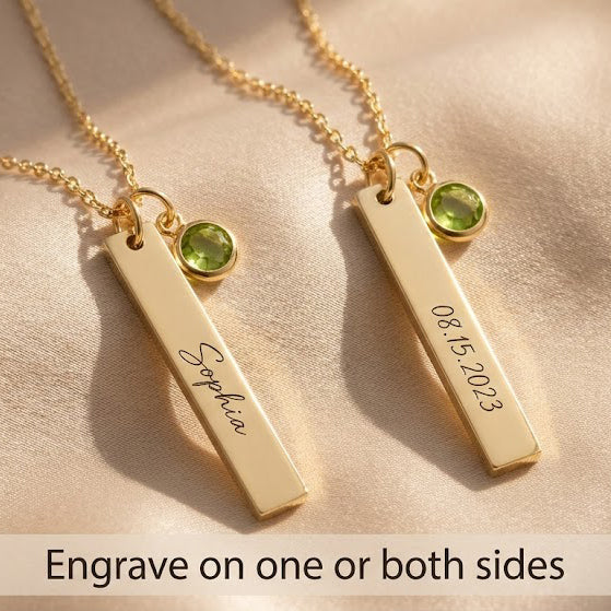 Front and back engraving examples on gold vertical bar necklaces with green checker-faceted birthstone charms.